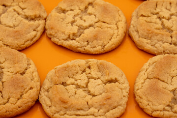 Peanut Butter cookies on a orange plate on a white background