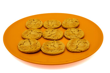 Peanut Butter cookies on a orange plate on a white background