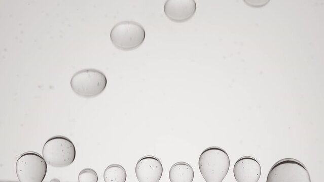 Shot of grey clear bubbles form and float on grey background | Abstract skincare cosmetics formulation concept