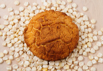 Traditional corn bread with corn in wood background