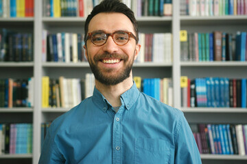 Bearded man spends productive day among books in library
