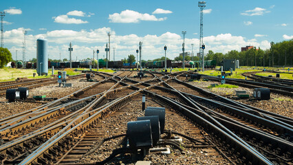 railway tracks, diesel locomotive and railway wagons against the blue sky