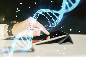 Creative DNA sketch and hand working with a digital tablet on background, biotechnology and genetic...