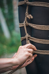 shibari woman breast in green body tied up with ropes by men