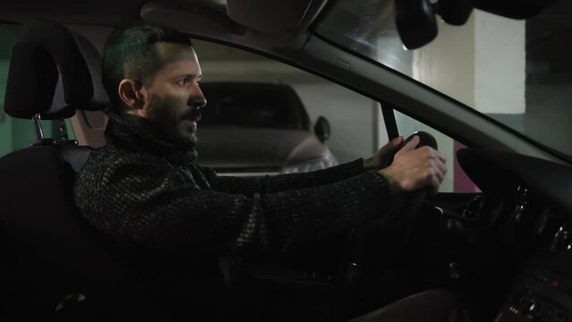 Angry man can't get out of the parking lot. Stressed driver getting mad and squeezing car wheel. Guy in automobile expressing negative emotions