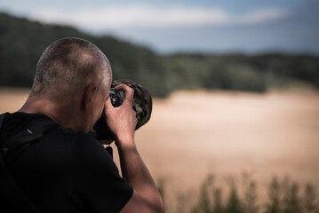 Masked wildlife photographer waiting for game in a game refuge, hidden and well hidden like a...