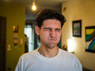 Obraz premium Young man with puffed cheeks, holding breath