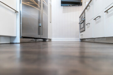 Dark wood hardwood floors in a newly renovated white cabinet modern kitchen