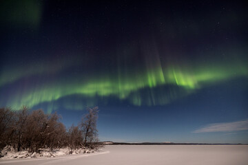 Northern lights aurora borealis over Lake Inari , Lapland, Finland