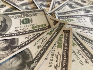 USA dollar bills, banknote, currency. 100 dollars bill banknote pile. Money dollars background photo. Dollar banknote closeup. A lot of dollars in the background
