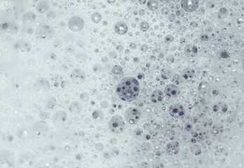 small soap bubbles on water surface, marco background