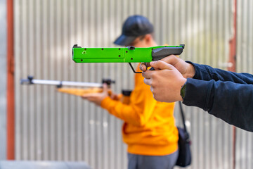 Hand-held laser sports pistol while aiming