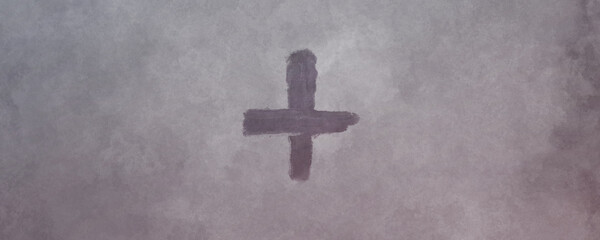 Cross made from ashes. Symbolic of Ash Wednesday. On vintage gray background.