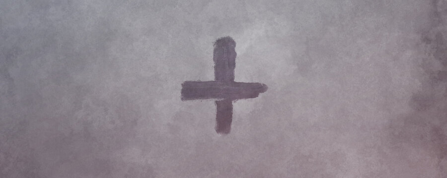 Cross made from ashes. Symbolic of Ash Wednesday. On vintage gray background.