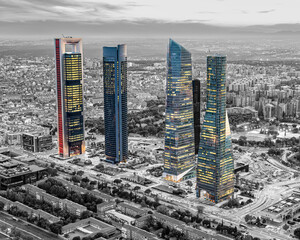 The 5 towers of Madrid in color, with the background in black and white during a sunset