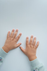 close up of little child hands on white 