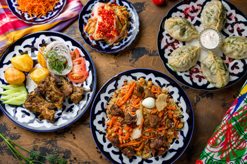 Fototapeta na wymiar dishes of Uzbek cuisine lagman, pilaf, manti with sour cream, kazan kebab with potatoes on old wooden table top view
