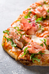 Pinsa with parma ham and aragula, rome pizza. macro close up vertical