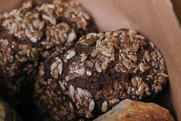 freshly baked bread in craft bags. Home baked whole grain bread. Crusty sourdough loaf of wheat bread with wholegrain flour. 