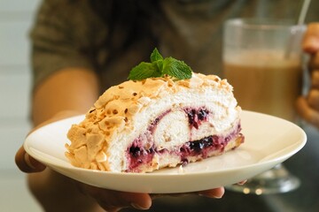 Meringue roll cake with cream, raspberries. Roulade, summer dessert. Confectionery, menu. Close up....