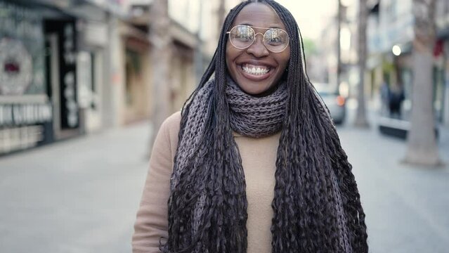 African woman smiling confident asking to come at street