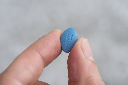 Man Hold Blue Pill Viagra In Fingers. Medicine Concept Of Men Health, Medication For Potency, Erection