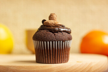 Chocolate muffin, dessert from a pastry shop, hand-made on a wooden board, dessert concept
