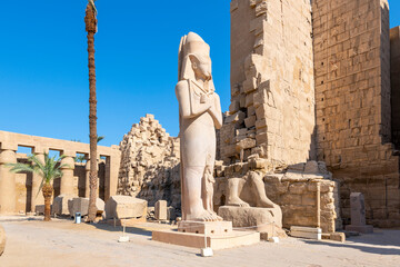 The monumental statue of King Ramesses II with Princess Bent'anta at his feet inside the Temple of...
