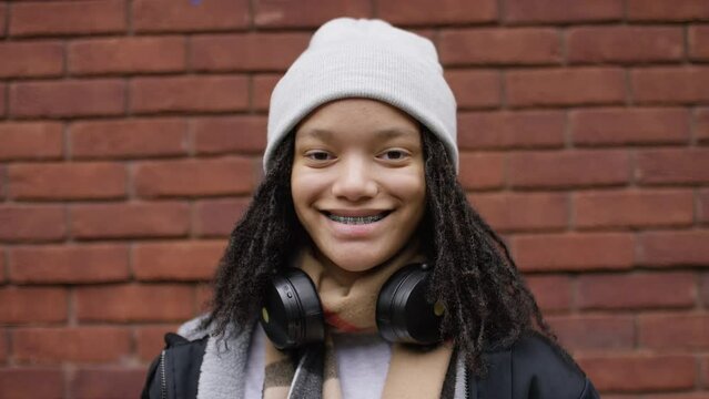 Portrait of smiling young teenager with braces looking to camera 