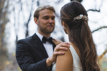 Young Wedding Couple looking at each other in fall park. High quality photo