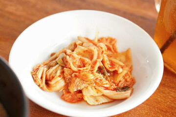 Kimchi, traditional Korean side dish. Served on white plate.