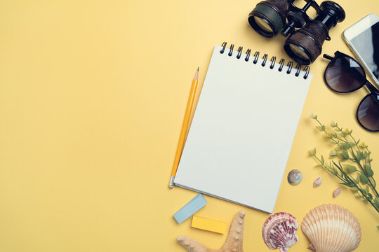 Flat Lay Concept Of Travel Accessories Vacation Trip And Long Summer Weekend Planning On Yellow Table With Blank Space For Text Background.