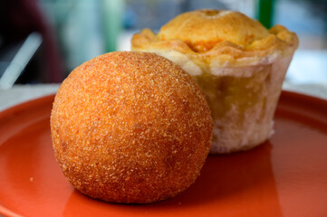 Traditional street food in UK, stuffed fried Scotch eggs with breadcrumbs and baked pie with pork meat