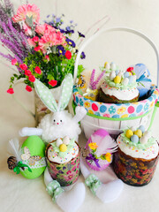 Easter colorful composition of bunny, basket and decorated eggs.