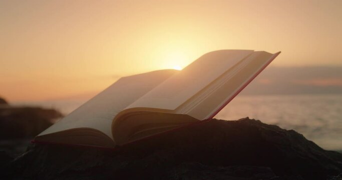 Open book on nature background. Learning is light and ignorance is darkness. Ancient scripture.