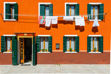 Linens on a clothesline along a facade