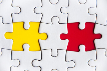 Missing jigsaw puzzle in red and yellow color with customizable space for text or ideas. Copy space.