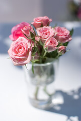small pink roses in a vase