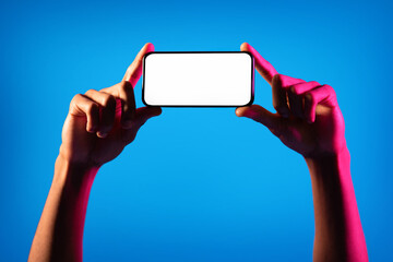 Black man hands holding cell phone with blank screen, mockup