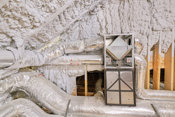 High efficiency energy recovery ventilator with door open in insulated home attic