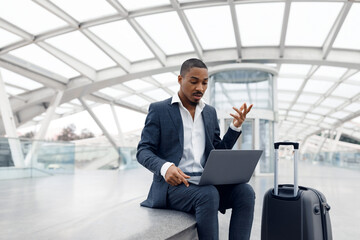 Video Call. Black Businessman Teleconferencing Via Laptop While Sitting At Airport