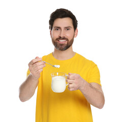 Fototapeta premium Handsome man with delicious yogurt and spoon on white background