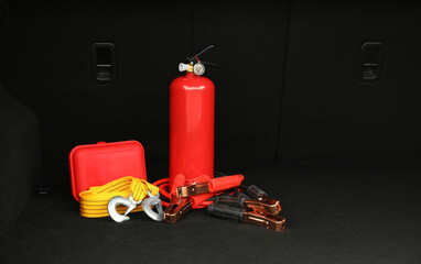 Red fire extinguisher, battery jumper cables, towing strap and first aid kit in trunk, space for...