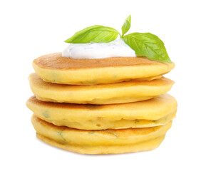 Stack of tasty corn pancakes with sauce and basil leaves isolated on white