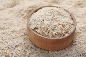 Wooden bowl of brewer`s yeast on flakes, closeup