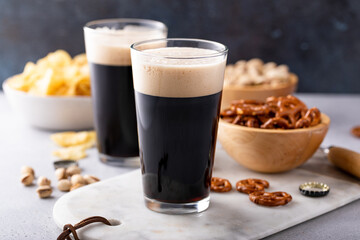 Dark stout beer in tall glasses on the table