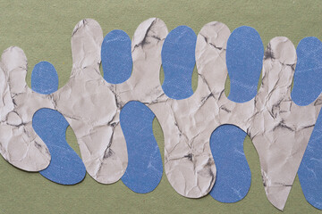 overlapping cut scrapbook paper with polyp or columnar edges on green