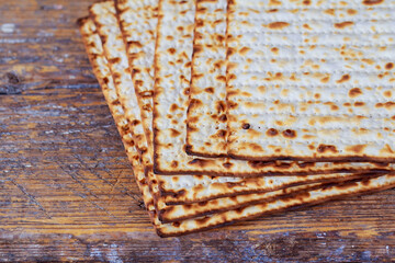 Passover matzoh jewish holiday bread over wooden table.