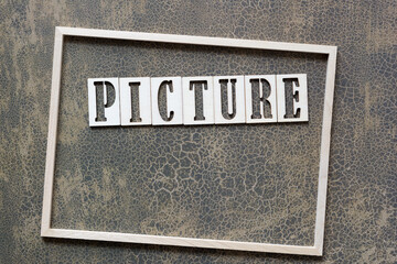 Fototapeta premium the word picture and thin wooden frame on textured scrapbook paper