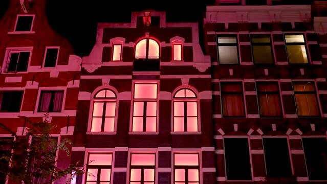 Amsterdam, Netherlands: Famous red light District at night. Brothels and sex shops. Red lights in brothel. Prostitution is legal in Amsterdam. 